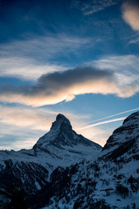 Scenic view of snowcapped mountains against sky during sunset