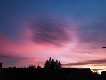 Low angle view of silhouette trees against sky at sunset