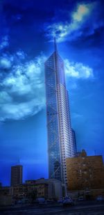 Low angle view of modern building against blue sky