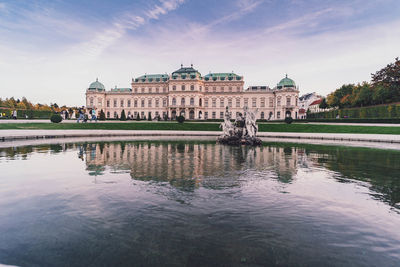 Belvedere palace in vienna at pink sunset and purple flowers