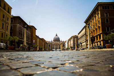 View of city street and buildings against sky