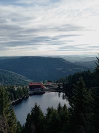 High angle view of river amidst trees against sky