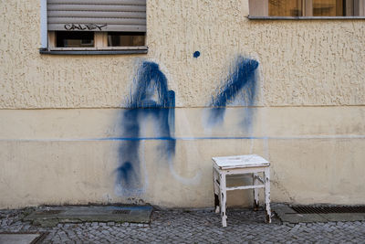 Chairs and table by wall in building