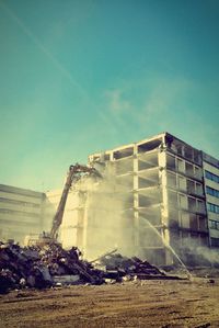 Garbage on construction site against clear blue sky