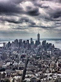 View of cityscape against cloudy sky