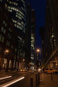 Illuminated city street and buildings at night