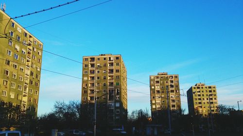 Low angle view of skyscrapers against clear blue sky