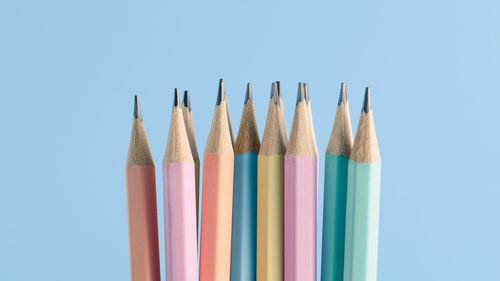 Close-up of colored pencils against blue background