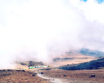 Smoke emitting from volcanic mountain against sky