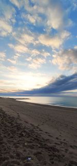 Scenic view of beach against sky during sunset