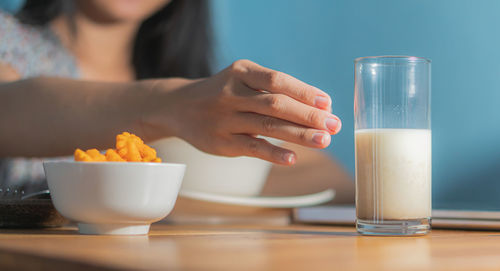 Midsection of woman holding drink