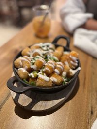 Loaded tater tots - cheddar, bacon, green onions and sour cream drizzle