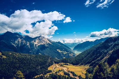 Scenic view of mountains against blue sky