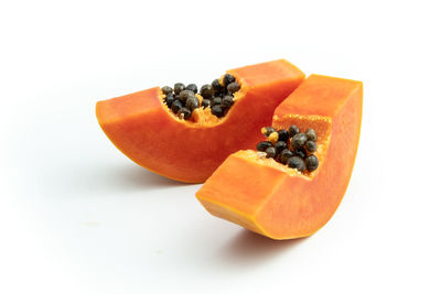 Close-up of orange fruit against white background