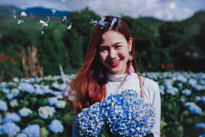 Portrait of smiling woman with flowers