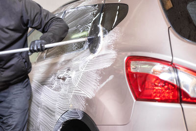 Midsection of man working on car