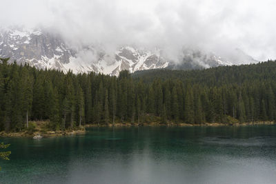 Scenic view of lake by mountains against sky