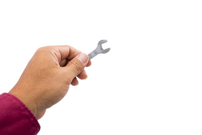 Close-up of hand holding hands over white background