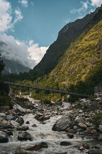 Scenic view of river amidst mountains against sky