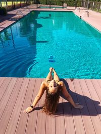 High angle view of woman relaxing in swimming pool