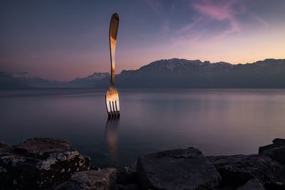 Scenic view of lake against sky during sunset