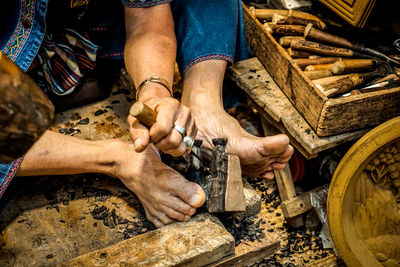 High angle view of artist carving wood