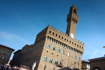 Low angle view of historical building against blue sky