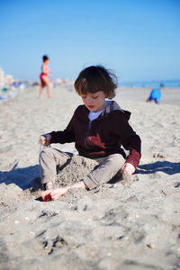 Boys sitting on beach