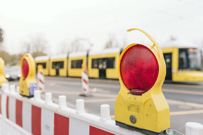 Close-up of stop light on barricade in city