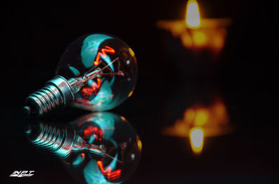 Close-up of illuminated light candles on table