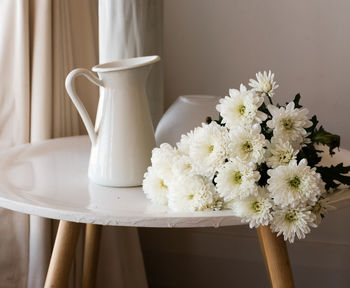 Close-up of white flower vase on table at home