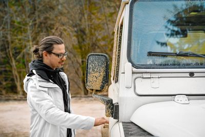 Man opening door of suv car. off-road concept