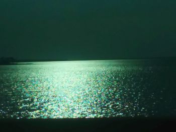 Scenic view of sea against sky at night