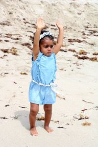 Full length of cute girl standing at beach
