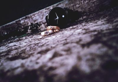 Close-up of wedding rings on rock