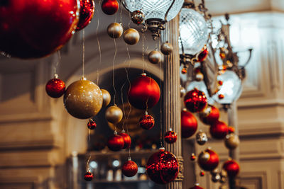Christmas glass red and golden balls hanging in the interior. new year details 