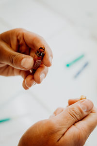 Close-up of human hand holding syringe