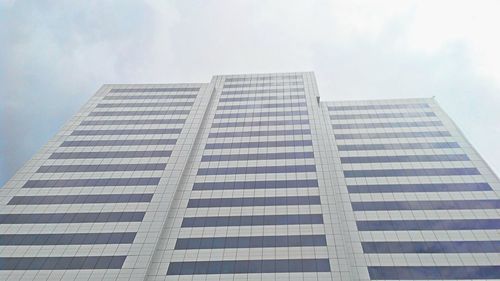 Low angle view of office building against sky