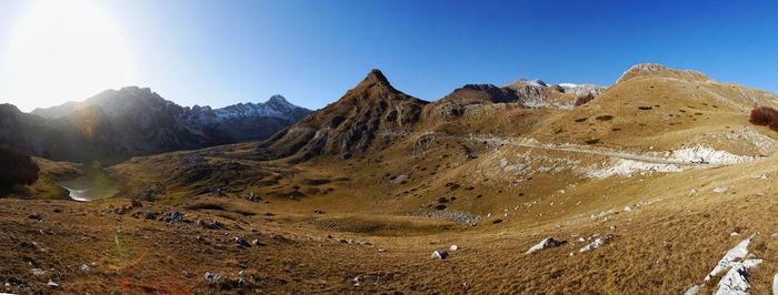 Panoramic view of snowcapped mountains against clear blue sky