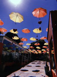 Low angle view of illuminated lanterns hanging against sky