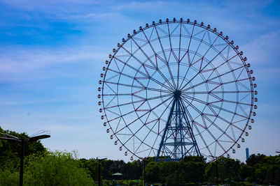 Low angle view of ferris wheel against sky