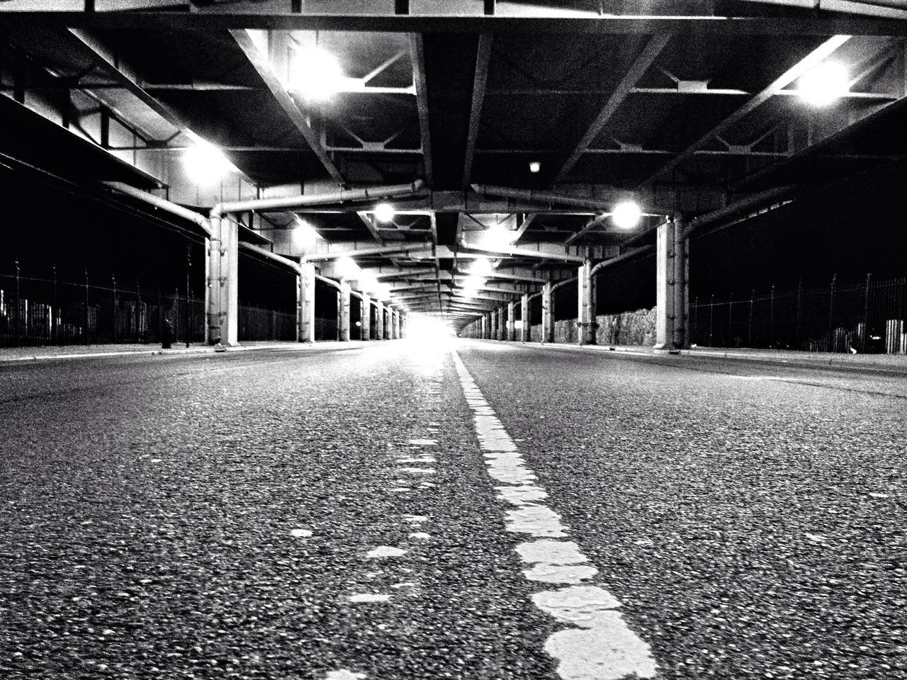 the way forward, illuminated, diminishing perspective, vanishing point, lighting equipment, empty, architecture, built structure, night, transportation, long, surface level, ceiling, absence, street light, street, cobblestone, light - natural phenomenon, road, indoors