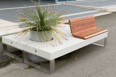 Empty chairs and table by bench