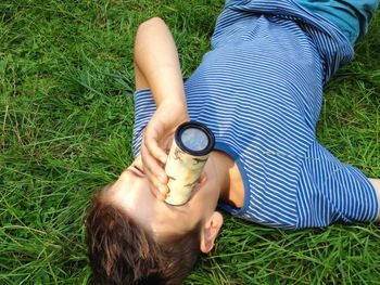 High angle view of woman lying on grass