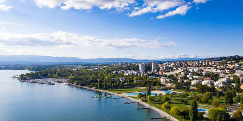 High angle view of river amidst buildings in city against sky