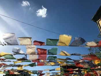 Low angle view of clothes drying against sky