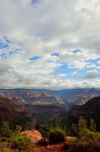 Scenic view of mountains against cloudy sky