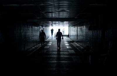 Rear view of silhouette people walking in subway