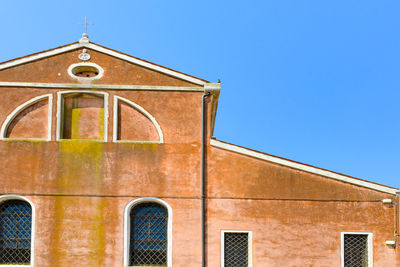 Low angle view of building against clear blue sky