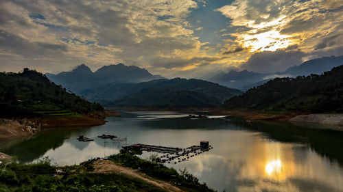 Scenic view of lake against sky during sunset